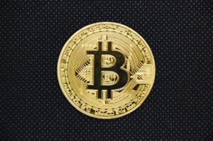 a gold coin with a bitcoin symbol on it