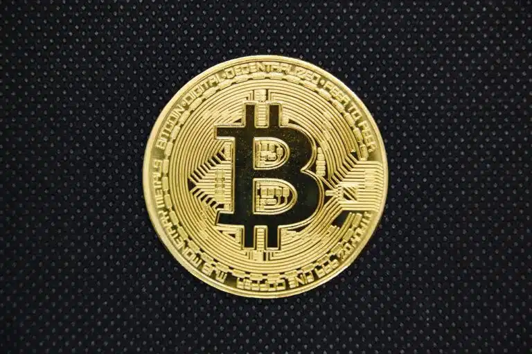 a gold coin with a bitcoin symbol on it