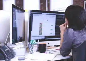 Person working intently at computer.