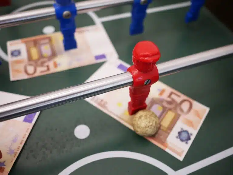 a foosball table with a ball on top of money