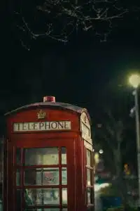 a red telephone booth at night