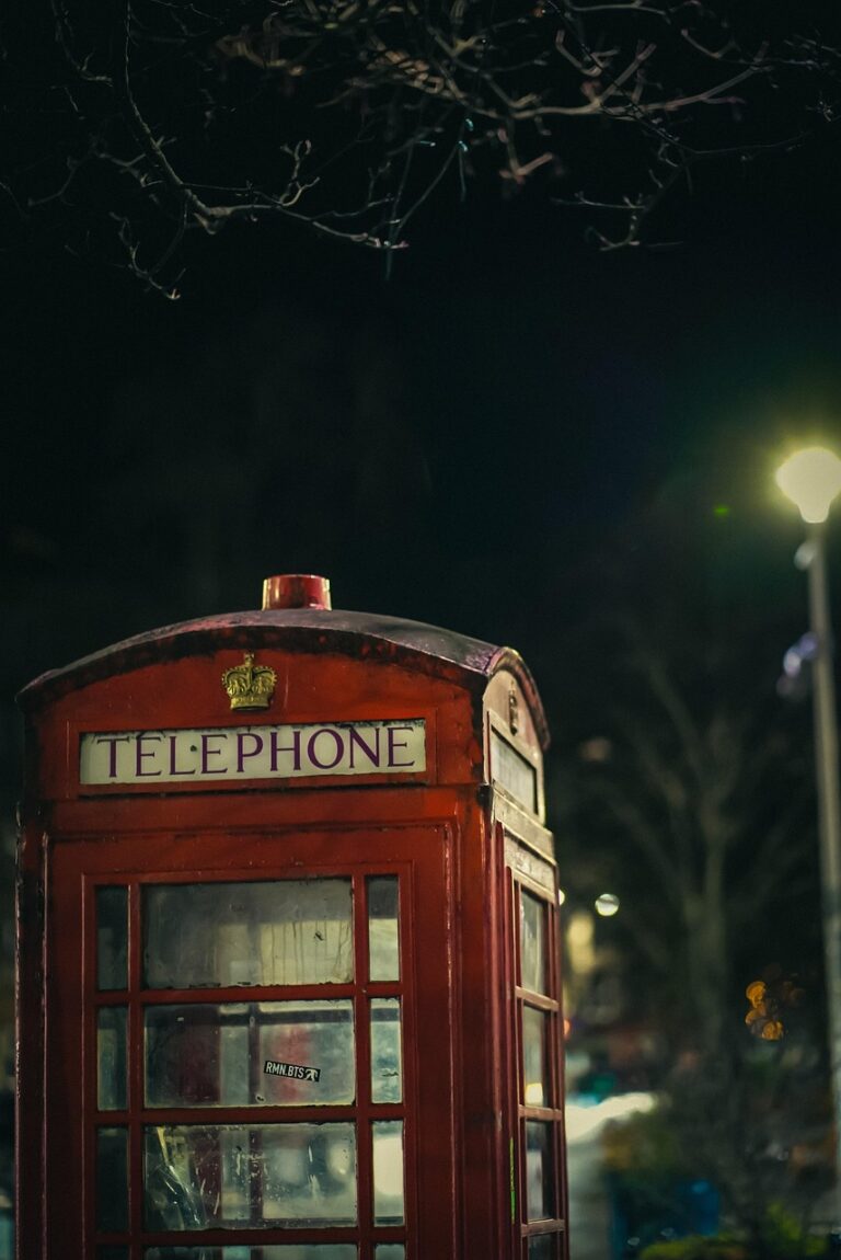 a red telephone booth at night