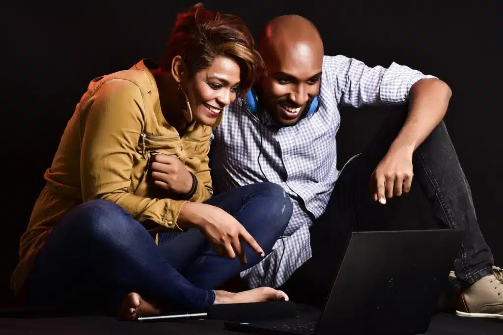 Couple enjoying time together on laptop.